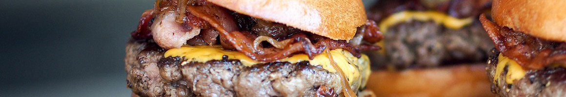 Eating Burger Sandwich at Jimbo’s Hamburger Palace restaurant in New York, NY.